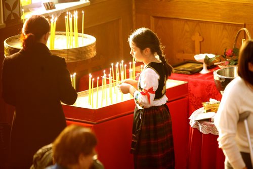Faith Page. A young girl lights a candle that represents the light of Jesus Christ after  baptism ceremony officiated by The Patriarch Irinej of the Serbian Orthodox Church from Belgrade at St. Slava Serbian Orthodox at 580 Talbot Ave Saturday.   See Brenda Suderman's story,  February 13, 2016 Ruth Bonneville / Winnipeg Free Press