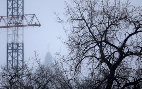 The Golden Boy, barely visible through a snow storm this morning, as seen from the Midtown Bridge, Sunday, February 14, 2016. (TREVOR HAGAN/WINNIPEG FREE PRESS)