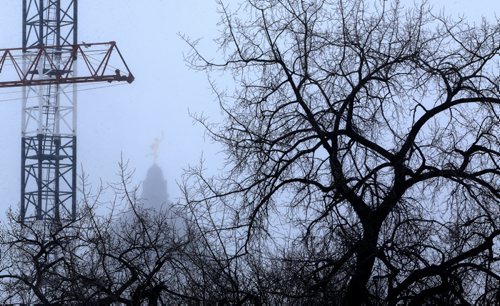 The Golden Boy, barely visible through a snow storm this morning, as seen from the Midtown Bridge, Sunday, February 14, 2016. (TREVOR HAGAN/WINNIPEG FREE PRESS)