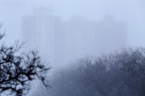 Apartments in Osborne Village, barely visible through a snow storm this morning, as seen from the Midtown Bridge, Sunday, February 14, 2016. (TREVOR HAGAN/WINNIPEG FREE PRESS)