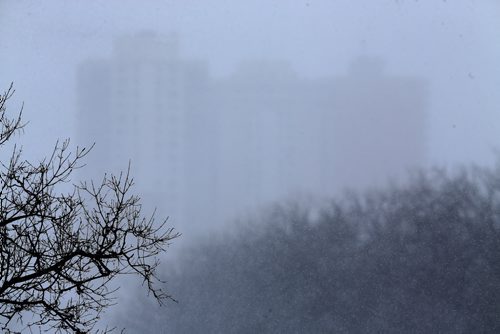 Apartments in Osborne Village, barely visible through a snow storm this morning, as seen from the Midtown Bridge, Sunday, February 14, 2016. (TREVOR HAGAN/WINNIPEG FREE PRESS)