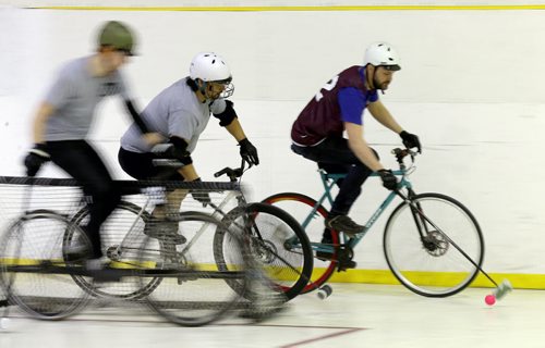 A team called 3M in the grey shirts, versus the Eyebrows in the purple jerseys, during a bike polo tournament at the Duncan Sportsplex, Sunday, February 14, 2016. (TREVOR HAGAN/WINNIPEG FREE PRESS)