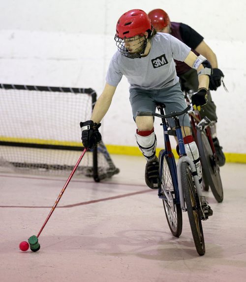 A team called 3M in the grey shirts, versus the Eyebrows in the purple jerseys, during a bike polo tournament at the Duncan Sportsplex, Sunday, February 14, 2016. (TREVOR HAGAN/WINNIPEG FREE PRESS)