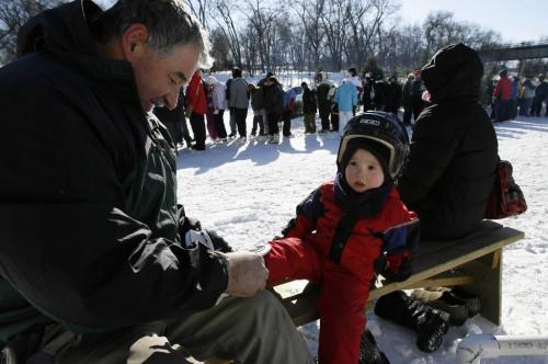 John Woods / Winnipeg Free Press / February 18, 2008 - 080218 - Three year old Jacob McCharles gets his skates fastened by grandpa James Hofer.  Winnipeggers came out in force to break the world skating record at the Forks Monday February 18, 2008. Over a thousand people broke the old record owned by a group in Mexico.