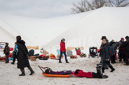 Mike Deal / Winnipeg Free Press Exhausted kids are dragged past one of the children's entertainment tents at the Festival du Voyageur on Louis Riel Day. 160215 - Monday, February 15, 2016
