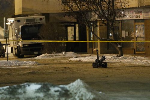 February 15, 2016 - 160215  -  Police robot makes it's way  across a parking lot to investigate a suspicious package at a Boston Pizza on McPhillips Monday, February 15, 2016. The robot shot the package to dispose of it. Police were called to the restaurant for a robbery and a suspected package was found at the scene. John Woods / Winnipeg Free Press