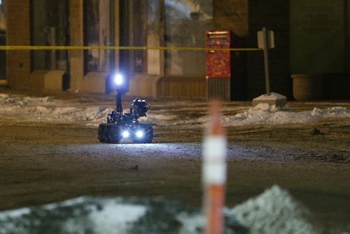 February 15, 2016 - 160215  -  Police robot makes it's way  across a parking lot to investigate a suspicious package at a Boston Pizza on McPhillips Monday, February 15, 2016. The robot shot the package to dispose of it. Police were called to the restaurant for a robbery and a suspected package was found at the scene. John Woods / Winnipeg Free Press
