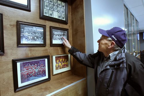 JOE BRYKSA / WINNIPEG FREE PRESS Manitou, Manitoba, Lewis Mueller looks at historical hockey team images of when he played inside the Manitou Community Arena many years ago, February 16, 2016.( See Randy Turner rural hockey rinks 49.8 story)