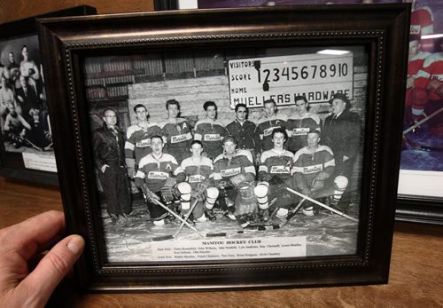 JOE BRYKSA / WINNIPEG FREE PRESS Manitou, Manitoba, Walter Mueller , front left, in historical hockey team image of when he played inside the Manitou Community Arena many years ago with his brother Louis , 3rd right backrow, and their father Otto as manager first right, February 16, 2016.( See Randy Turner rural hockey rinks 49.8 story)