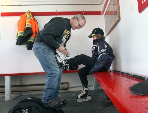 JOE BRYKSA / WINNIPEG FREE PRESS Manitou, Manitoba, Claire Jago helps his son Max, 10 yrs put on his skates in the warming hut at the Pembina Manitou outdoor rink, February 16, 2016.( See Randy Turner rural hockey rinks 49.8 story)