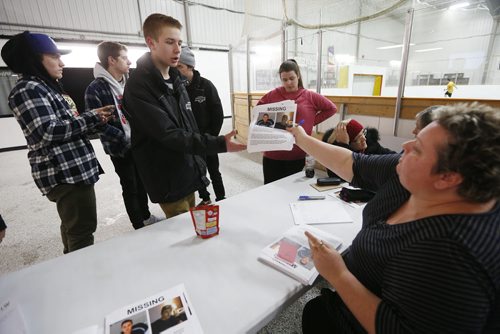 JOHN WOODS / WINNIPEG FREE PRESS Corie Siddle hands "Missing" posters to Kris Hrom, Nolan Koop, Carsen Sobey and Curtis Rebeck, teammates of Cooper Nemeth on River East Marauders, as they and hundreds of volunteers came together at Gateway Recreation Centre to search for Nemeth Tuesday, February 16, 2016. Cooper Nemeth was last seen early Sunday morning at a party in Valley Gardens.