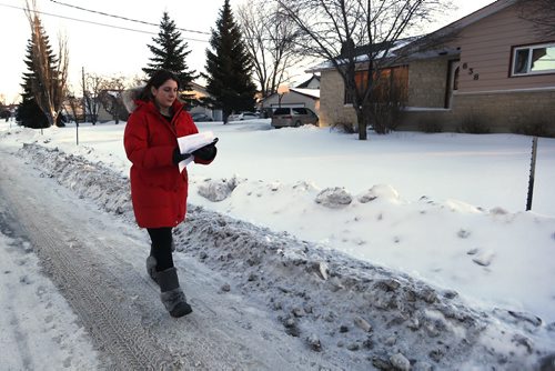 JOHN WOODS / WINNIPEG FREE PRESS Laresa Sayles, aunt of Cooper Nemeth, goes door to door with hundreds of volunteers who gathered at Gateway Recreation Centre to search for Nemeth Tuesday, February 16, 2016. Cooper Nemeth was last seen early Sunday morning at a party in Valley Gardens.