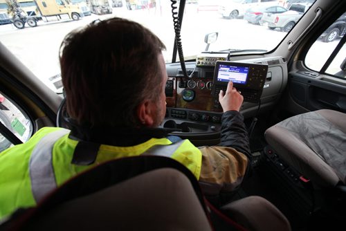 Ruth Bonneville / Winnipeg Free Press Bison Transport driver and instructor, Rob Rudyk logs his driving hours with an electronic logging device (ELD) in the parking lot at the Bison headquarters in Winnipeg Wednesday. See Biz story by Murray McNeill.  Feb 17, 2016