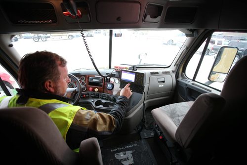 Ruth Bonneville / Winnipeg Free Press Bison Transport driver and instructor, Rob Rudyk logs his driving hours with an electronic logging device (ELD) in the parking lot at the Bison headquarters in Winnipeg Wednesday. See Biz story by Murray McNeill.  Feb 17, 2016