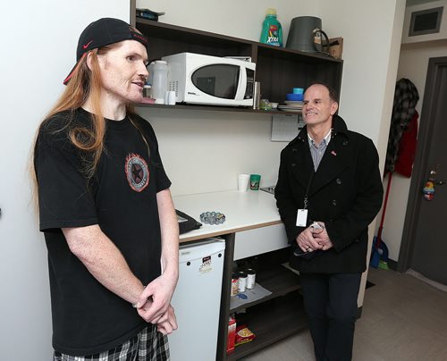 JASON HALSTEAD / WINNIPEG FREE PRESS Jonah Young shows off his apartment at The Bell on Main Street with Rick Lees, director of development for Main Street Project, on Jan. 27, 2016. Young, who was formerly homeless, has lived at The Bell since it opened in fall 2011. (See Social Page)
