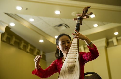 DAVID LIPNOWSKI / WINNIPEG FREE PRESS 160218  Ruyu Zhao of The Guizhou Culture Exchange Performing Arts Troupe plays the Pei Pa at the Best Western Plus Winnipeg Airport Hotel Thursday February 18, 2016.  The media got a sneak peek of the 2016 Chinese New Year Celebration Show (hosted by Manitoba Great Wall Performing Arts) which featured acrobatics, dance and musical performances. The show is on February 20, 2016, 7 PM, at the Pantages Playhouse Theatre.
