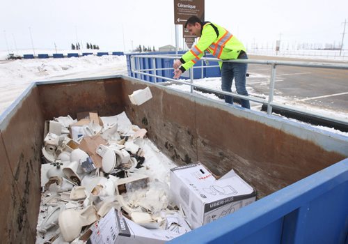 JOE BRYKSA / WINNIPEG FREE PRESSSimon Strauman of the City of Winnipeg shows used toilet bin outside the new Household Hazardous and Special Waste depot at the Brady landfill that will let Winnipegers drop off recyclables and hazardous waste for free , February 18, 2016.( See Aldo story)