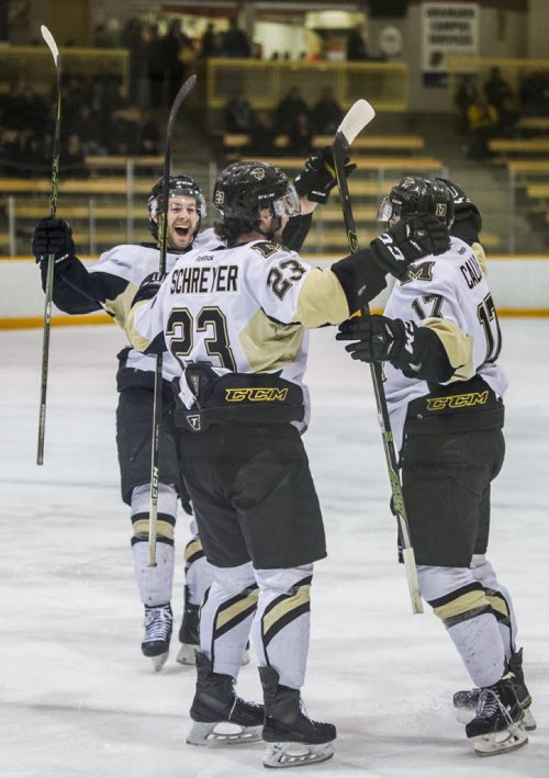 DAVID LIPNOWSKI / WINNIPEG FREE PRESS  University of Manitoba Bisons celebrate their first period goal against the University of Calgary Dinos Friday February 19, 2016 at Wayne Fleming Arena at Max Bell Centre. This is the first game in the Canada West Quarter Final best-of-three playoff series.