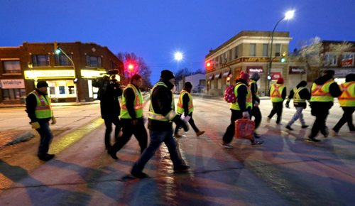 TREVOR HAGAN / WINNIPEG FREE PRESS Mitch Bourbonniere, middle, leads the Bear Clan as they search the North End for Cooper Nemeth, the missing 17 year old, Saturday, February 20, 2016.