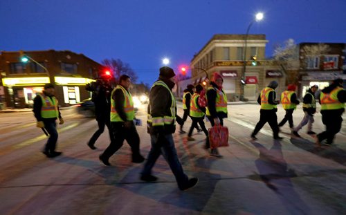 TREVOR HAGAN / WINNIPEG FREE PRESS Mitch Bourbonniere, middle, leads the Bear Clan as they search the North End for Cooper Nemeth, the missing 17 year old, Saturday, February 20, 2016.