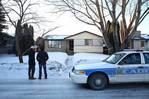 MIKE DEAL / WINNIPEG FREE PRESS A couple of neighbours chat outside number 10 Bayne Crescent early Sunday morning. Police tape and a couple of police cadets vehicles are the only sign that Cooper Nemeth's body was located late Saturday night nearby.  160221 February 21, 2016