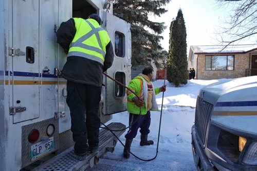 MIKE DEAL / WINNIPEG FREE PRESS City crews arrive to help with the investigation outside number 10 Bayne Crescent Sunday morning. Police are melting snow looking for evidence near where Cooper Nemeth's body was located late Saturday night.  160221 February 21, 2016