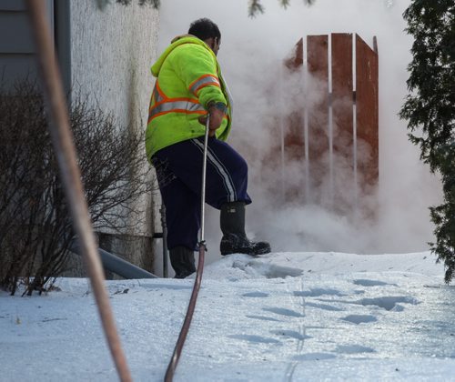 MIKE DEAL / WINNIPEG FREE PRESS City crews arrive to help with the investigation outside number 10 Bayne Crescent Sunday morning. Police are melting snow looking for evidence near where Cooper Nemeth's body was located late Saturday night. 160221 - Sunday, February 21, 2016
