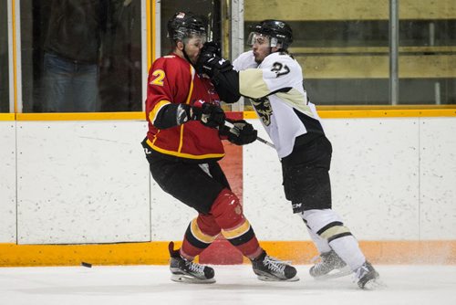 MIKE DEAL / WINNIPEG FREE PRESS University of Manitoba Bisons Jordan DePape (27) knocks University of Calgary Dinos Dan Gibb (2) off the puck in the third game of the Canada West quarter final best-of-three playoff series at Max Bell Arena. 160221 - Sunday, February 21, 2016