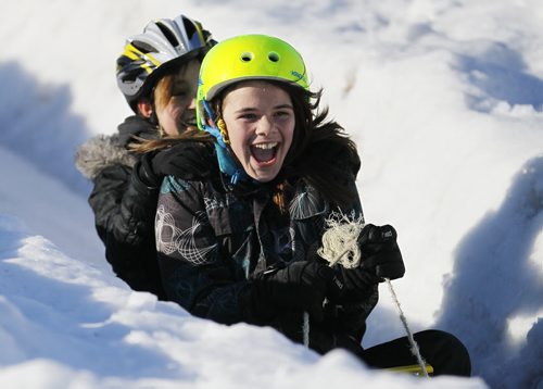 JOHN WOODS / WINNIPEG FREE PRESS Friends Alyssa Vanosch (front) and Mariah Vandenbushon slide down a hill on the last day of the Festival du Voyageur Sunday , February 21, 2016.