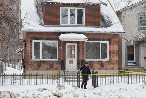MIKE DEAL / WINNIPEG FREE PRESS Winnipeg Police Service officer outside a house on Pritchard Ave where it is believed a body has been discovered.  160222 February 22, 2016