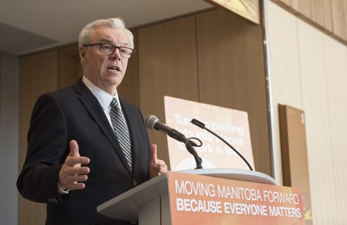 DAVID LIPNOWSKI / WINNIPEG FREE PRESS   NDP Manitoba Party Leader and Premier of Manitoba Greg Selinger makes a surface parking lot announcement flanked by  MLA's Flor Marcelino and Melanie Wight in the lobby of the RBC Convention Centre lobby Tuesday February 23, 2016.