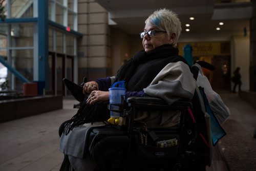 MIKE DEAL / WINNIPEG FREE PRESS Terry McIntosh, a Handi Transit user waiting for her handi transit bus behind the Portage Place Promenade. 160224 - Wednesday, February 24, 2016