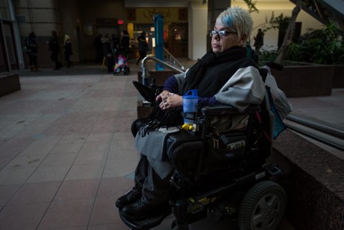 MIKE DEAL / WINNIPEG FREE PRESS Terry McIntosh, a Handi Transit user waiting for her handi transit bus behind the Portage Place Promenade. 160224 - Wednesday, February 24, 2016