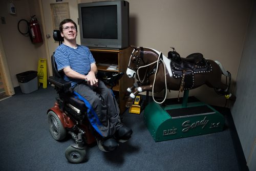 MIKE DEAL / WINNIPEG FREE PRESS Luke Savoie, is now an adult with cerebral palsy, but when he was a kid Sandy the horse (a coin operated horse in the X-ray area waiting room) really helped him with getting X-rays. He was visiting the Rehabilitation Centre for Children at the 633 Wellington Cres. location, which will soon become the old location as a building on Notre Dame Ave is in the final stages of being renovated. 160224 - Wednesday, February 24, 2016