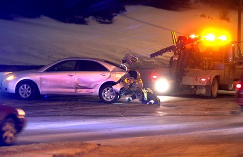 BORIS MINKEVICH / WINNIPEG FREE PRESS MVC on southbound rt90 between Ness and Portage Ave. Towtruck driver gets ready to tow the wrecked car. NO OTHER INFO ON CRASH. Photo taken February 24, 2016