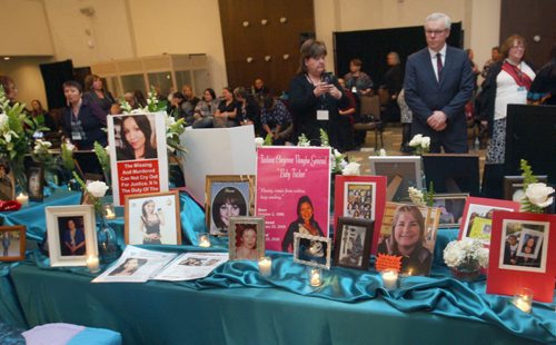 JOE BRYKSA / WINNIPEG FREE PRESS  Premier Greg Selinger takes a moment to look at  table covered in photos of victims at  the Second National Roundtable on Missing and Murdered Indigenous Women and Girls in Winnipeg Feb. 24 to 26 , February 25, 2016.( See Alex Paul story)