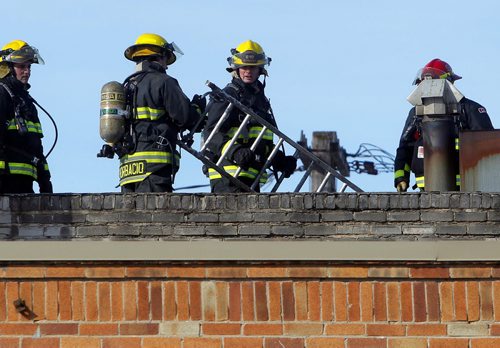 BORIS MINKEVICH / WINNIPEG FREE PRESS Fire crews work tirelessly on the roof of the 2 alarm fire in the old Legion on Sargent and Maryland. The fire gutted the building and had over 10 fire trucks brought into the battle. Photo taken February 26, 2016