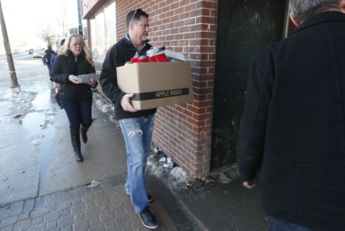 JOHN WOODS / WINNIPEG FREE PRESS Nemeth family members carry supplies into Ndinawe Youth Resource Centre for a meal they were preparing for the Bear Clan Patrol Friday, February 26, 2016. The Nemeths provided a meal to thank the patrol for the service they provided while the Nemeths were searching for their son Cooper.