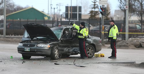 JASON HALSTEAD / WINNIPEG FREE PRESS  Police work at the scene of a two-car fatal MVA at the intersection of Jarvis Avenue and McPhillips Street on Feb. 27, 2016.