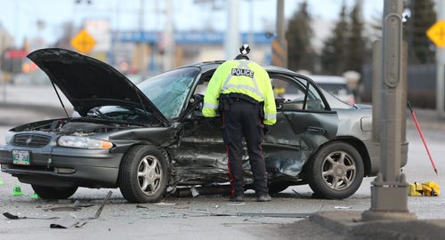 JASON HALSTEAD / WINNIPEG FREE PRESS  Police work at the scene of a two-car fatal MVA at the intersection of Jarvis Avenue and McPhillips Street on Feb. 27, 2016.
