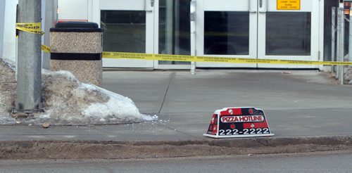 JASON HALSTEAD / WINNIPEG FREE PRESS  Police work at the scene of a two-car fatal MVA at the intersection of Jarvis Avenue and McPhillips Street on Feb. 27, 2016. A Pizza Hotline vehicle sign was on the roadside at the crash scene.