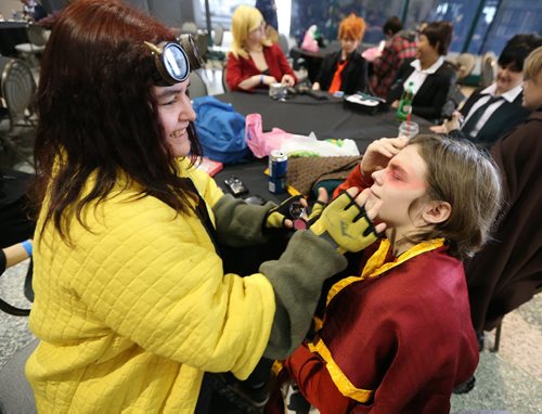 JASON HALSTEAD / WINNIPEG FREE PRESS  Danielle Mitchell (left), dressedup at Hufflepuff Chaser from Harry Potter, touches up the makeup of Daniel Macpherson, dressed at Zuko from 'Avatar,' at the fifth annual Ai-Kon Winter Festival at the RBC Convention Centre on Feb. 27, 2016. The event, which focuses on anime, featured exhibitors and vendors, artist's alley, as well as a gamers' lounge, Mario Kart 8 and Super Smash Bros 4 tournaments and dance.