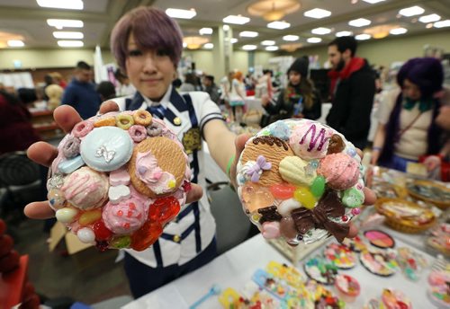 JASON HALSTEAD / WINNIPEG FREE PRESS  Yasuko Akimoto, owner of St. Boniface restaurant and gift shop Dwarf no Cachette, shows off her ceramic works at her vendor stall  at the fifth annual Ai-Kon Winter Festival at the RBC Convention Centre on Feb. 27, 2016. The event, which focuses on anime, featured exhibitors and vendors, artist's alley, as well as a gamers' lounge, Mario Kart 8 and Super Smash Bros 4 tournaments and dance.