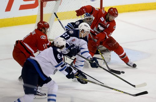 TREVOR HAGAN / WINNIPEG FREE PRESS Manitoba Moose goaltender Eric Comrie is screened by Charlotte Checkers' Kyle Hagel (18) with Moose Jake Baker (6) and Aaron Harstad (27) battling with Zach Boychuk (11) in front of the net during first period AHL hockey action at MTS Centre, Saturday, February 27, 2016.