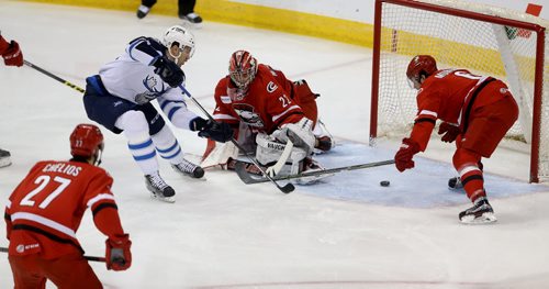TREVOR HAGAN / WINNIPEG FREE PRESS Manitoba Moose Patrice Cormier (28) scores on Charlotte Checkers' goaltender Drew MacIntyre (22) as Ryan Murphy (6) looks on during first period AHL hockey action at MTS Centre, Saturday, February 27, 2016.