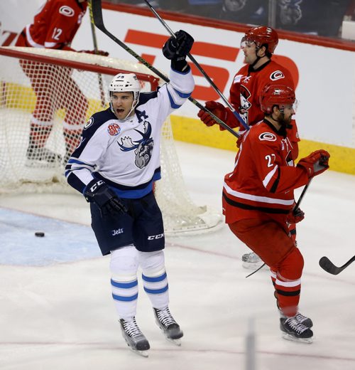TREVOR HAGAN / WINNIPEG FREE PRESS Manitoba Moose Patrice Cormier (28) scores on Charlotte Checkers' goaltender Drew MacIntyre (22) as Ryan Murphy (6) and Jake Chelios (27) look on during first period AHL hockey action at MTS Centre, Saturday, February 27, 2016.