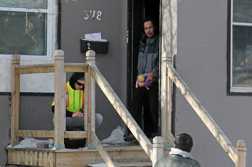 TREVOR HAGAN / WINNIPEG FREE PRESS Cyril Bruce removes some of his belongings from a house on Alexander Avenue after an overnight fire killed two people, Sunday, February 28, 2016.