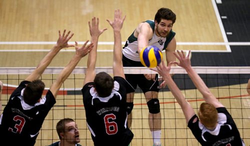 TREVOR HAGAN / WINNIPEG FREE PRESS University of Saskatchewan Huskies, Jordan Nowakowski, hits over the University of Winnipeg Wesmen's block, during CIS playoff volleyball action, Sunday, February 28, 2016.