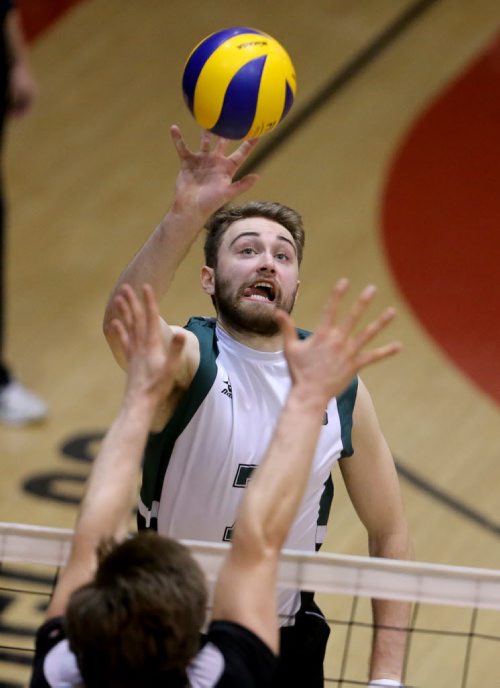 TREVOR HAGAN / WINNIPEG FREE PRESS University of Saskatchewan Huskies, Andrew Nelson, hits over the University of Winnipeg Wesmen's block, during CIS playoff volleyball action, Sunday, February 28, 2016.