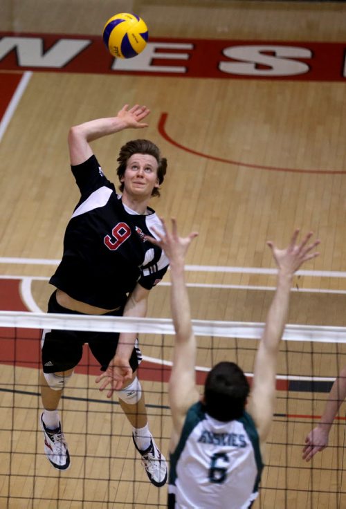 TREVOR HAGAN / WINNIPEG FREE PRESS University of Winnipeg Wesmen's David Bommersbach hits over the University of Saskatchewan Huskies block during CIS playoff volleyball action, Sunday, February 28, 2016.